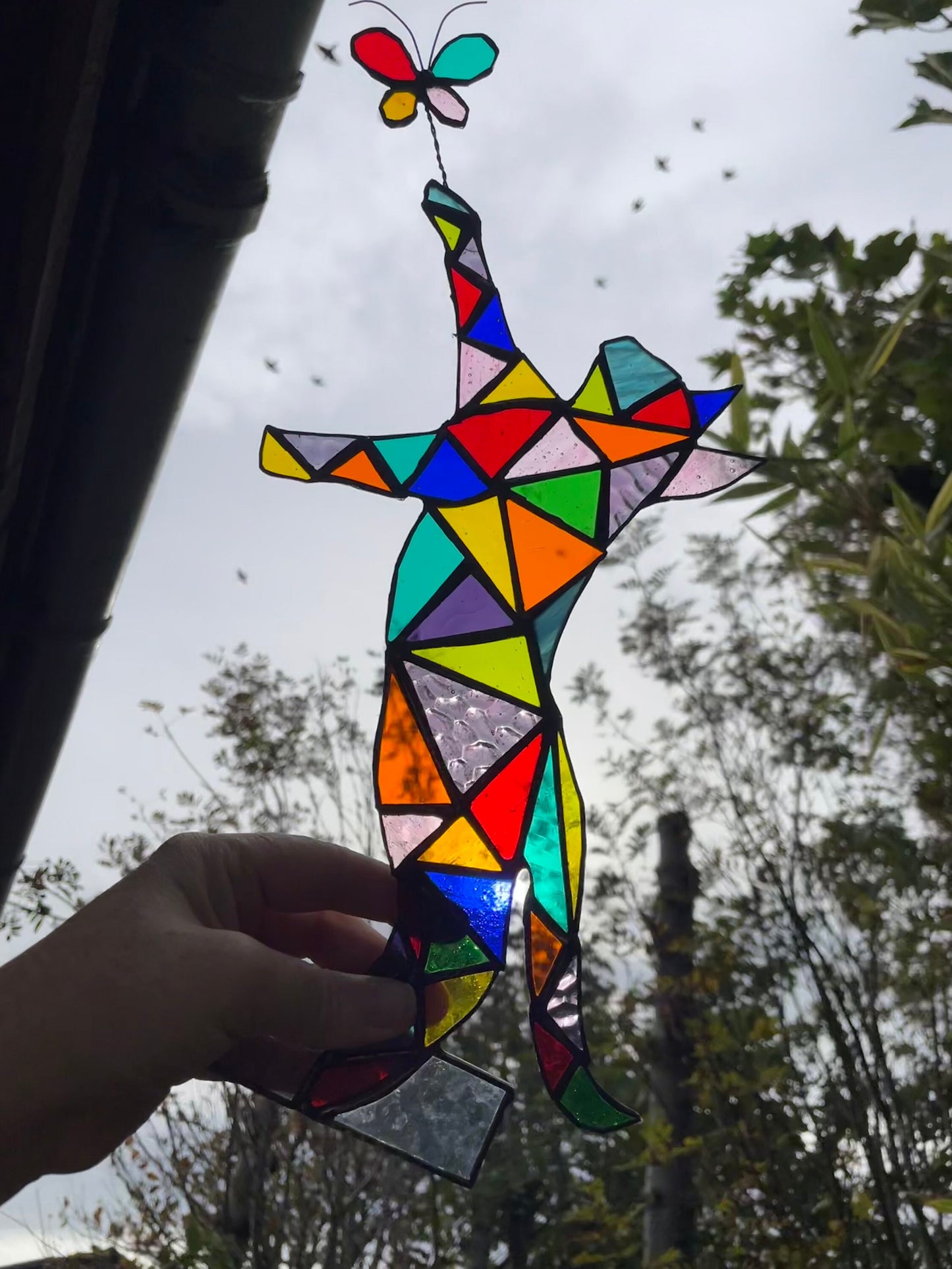 Stained glass cat chasing a butterfly with light, unique colourful rainbow gift