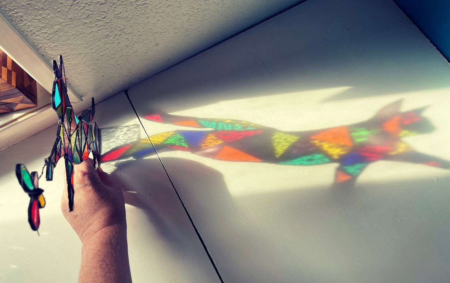 Stained glass cat chasing a butterfly with light, unique colourful rainbow gift